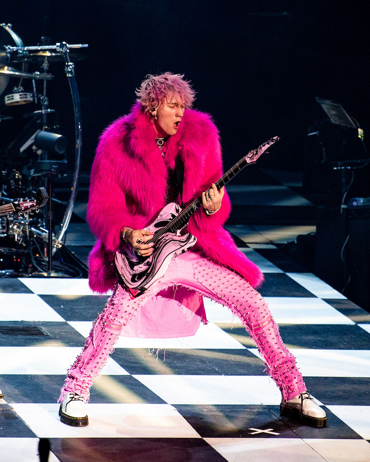 Machine Gun Kelly playing guitar at Huntington Bank Field